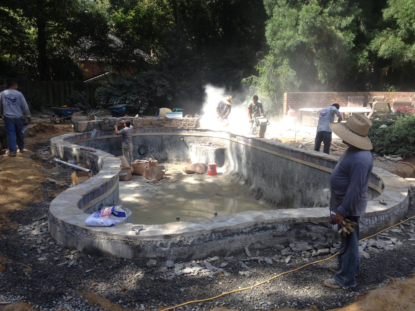 Group pf workers working at a site making a pool