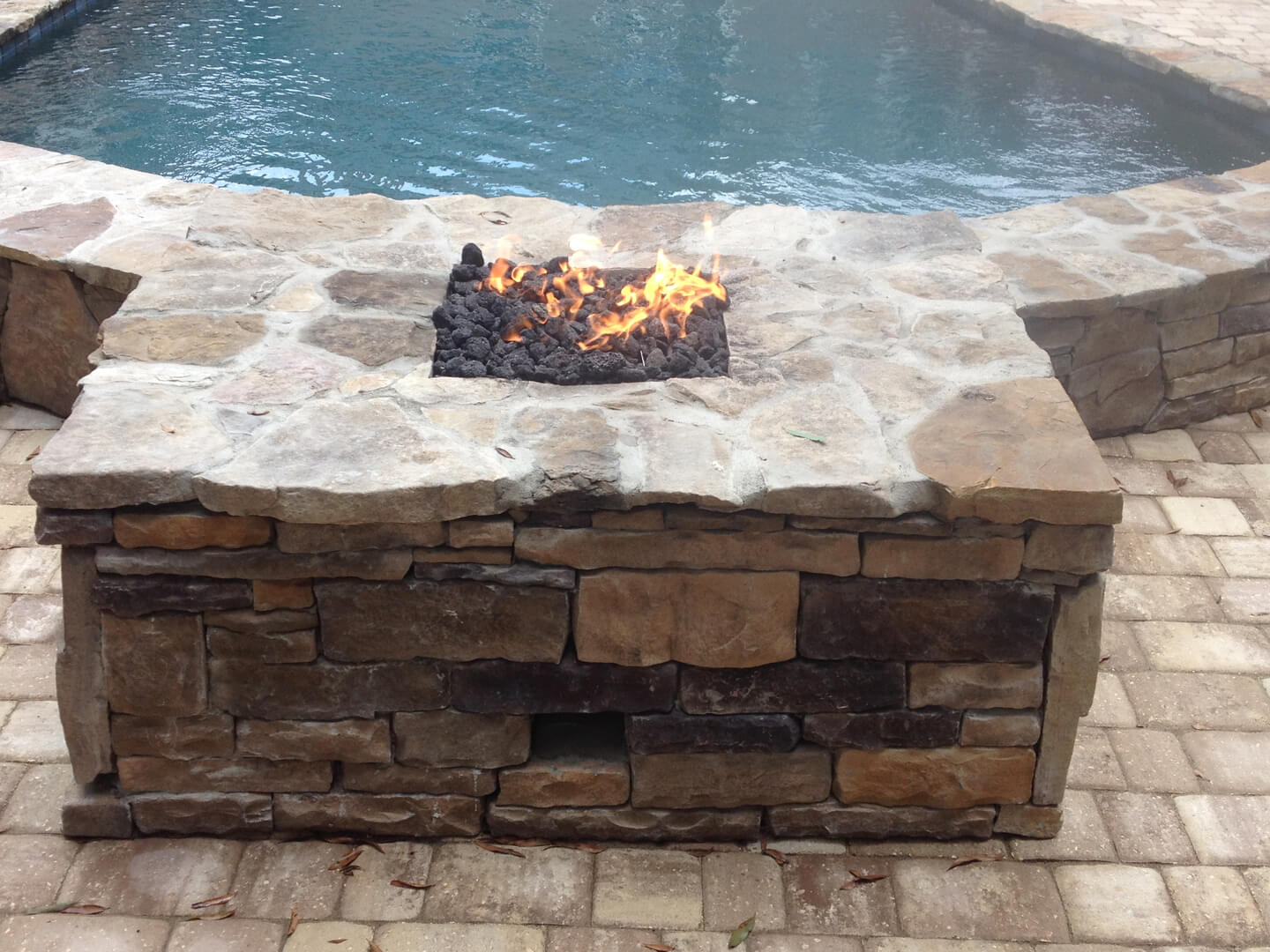 a fire place near a swimming pool